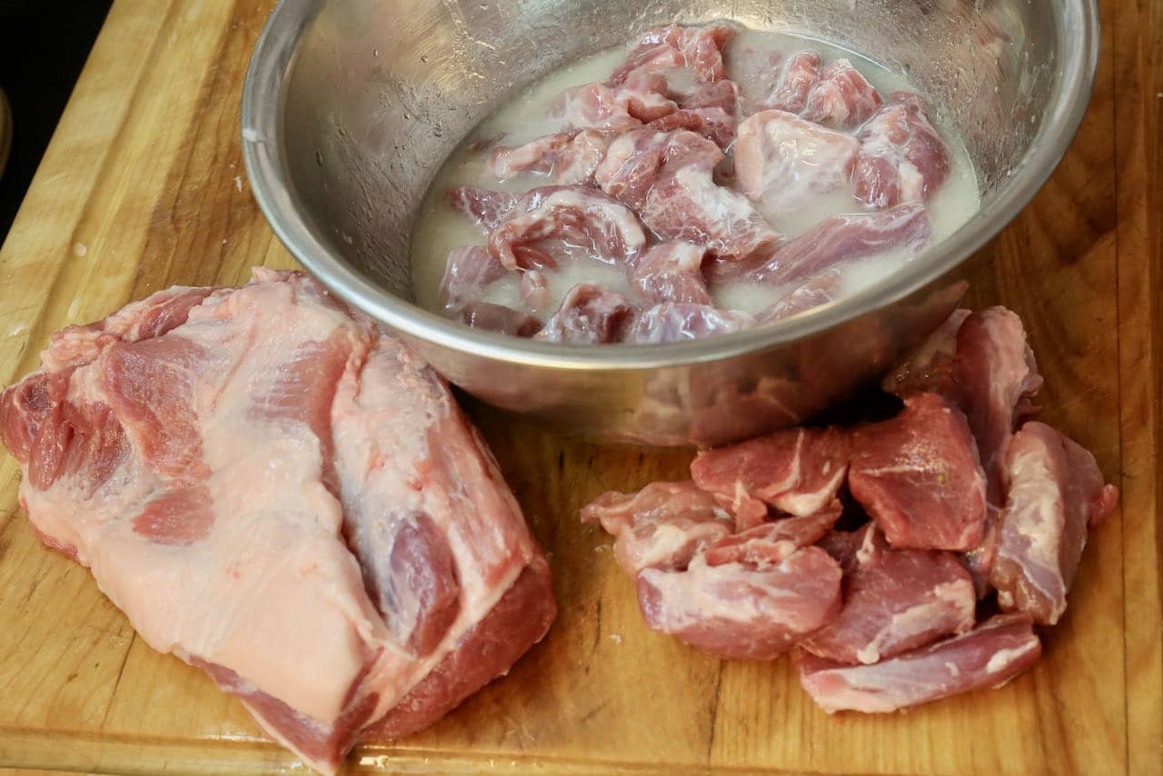 Slice the pork shoulder into strips and toss in marinade. 