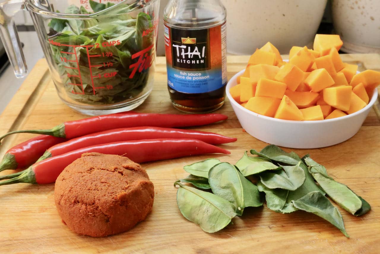 Traditional Thai Pork Curry is prepared with squash, red curry paste, fish sauce, basil, chilies and lime leaf.