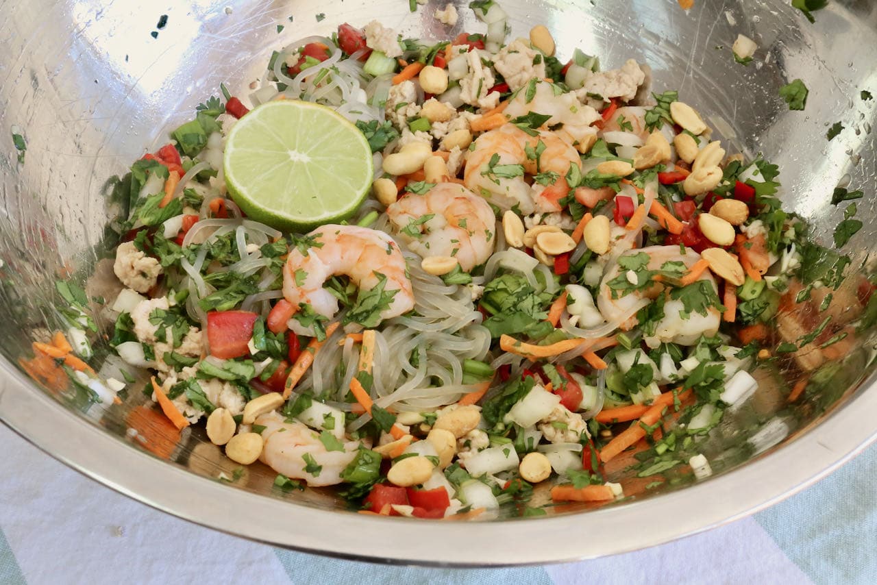 Toss Thai Glass Noodle Salad recipe ingredients in a large mixing bowl.