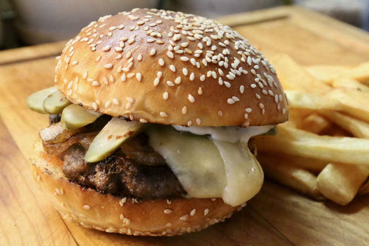 The best French burger features melted cheese, Parisian pickles and garlic aioli.