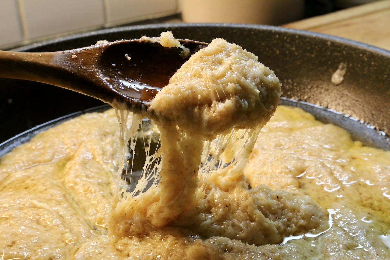 Kuymak is ready to serve once the melted cheese and cornmeal combines into a stringy mixture and fat begins to seperate.