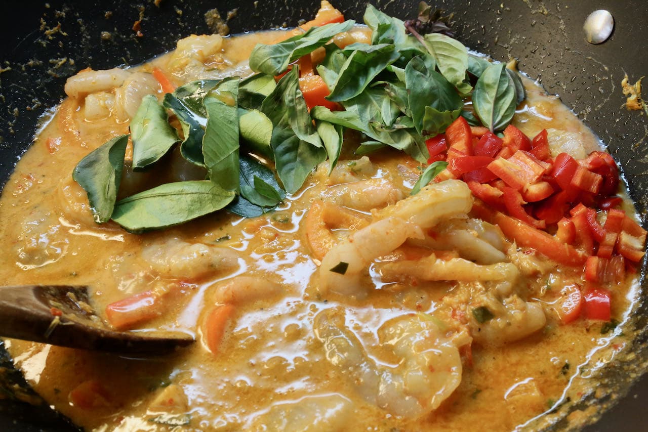 Cook authentic Shrimp Panang Curry in a large wok.