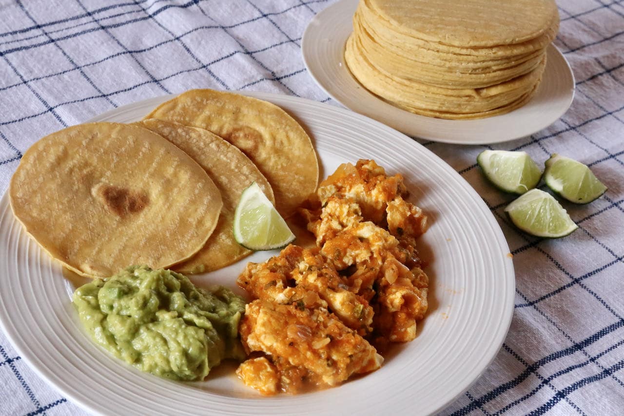 You can serve Salsa de Huevo on individual plates with tortillas, guacamole and lime.