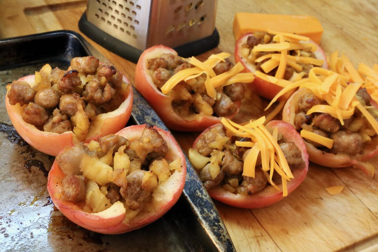 Sprinkle Sausage Stuffed Apples with shredded cheese.