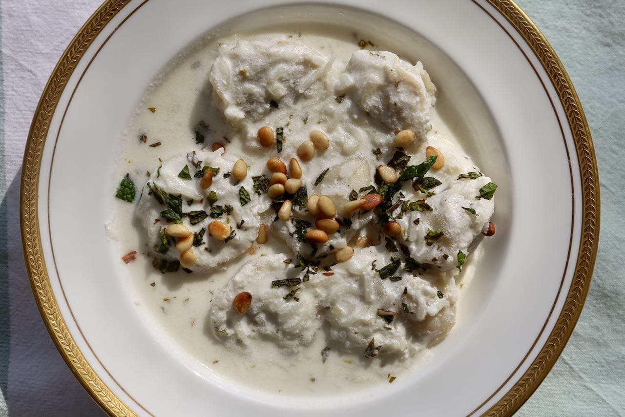 Enjoy Shish Barak as dumplings lightly coated with yogurt sauce or as a soup.