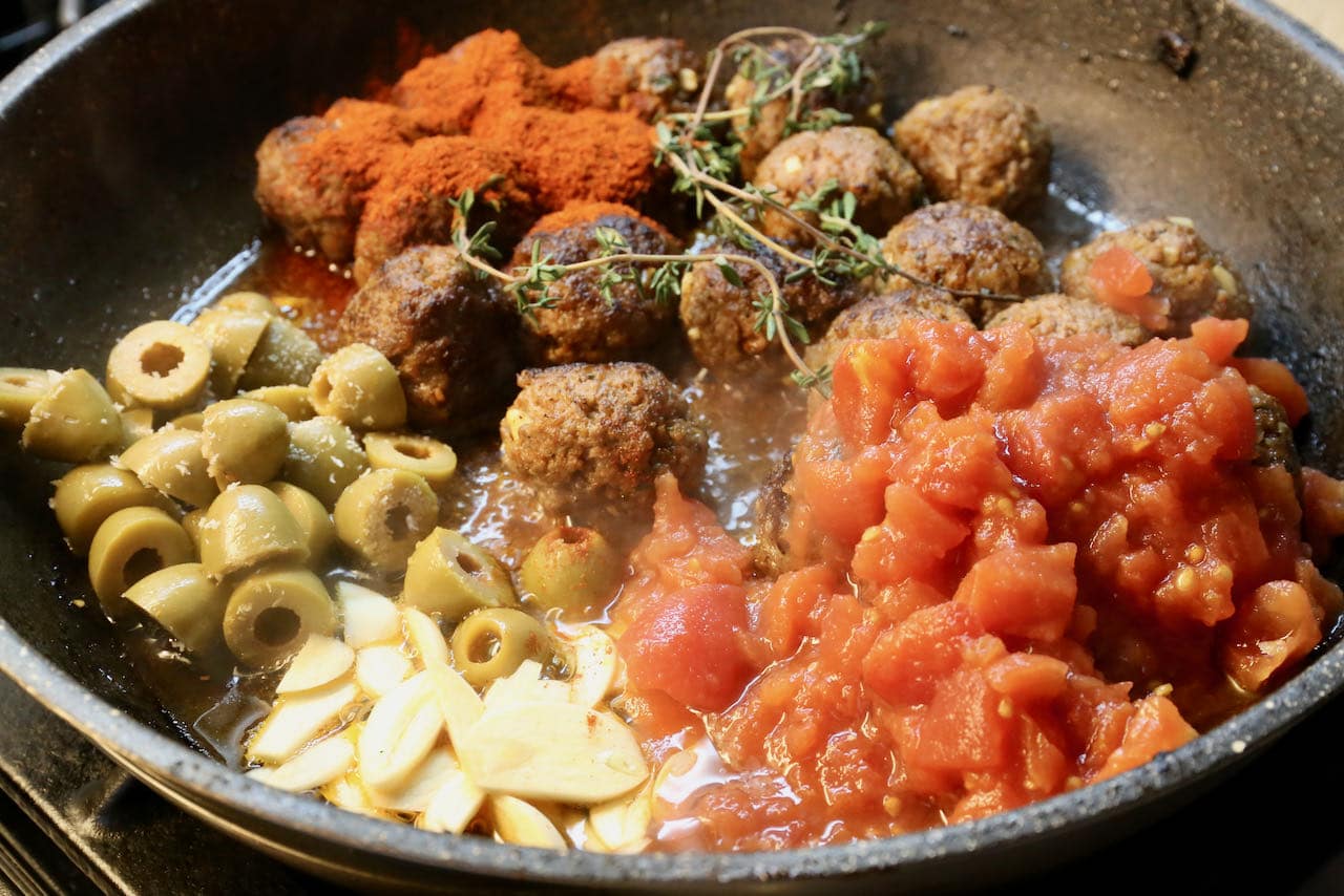 In a large skillet simmer Spanish Meatballs with tomatoes, olives and garlic. 