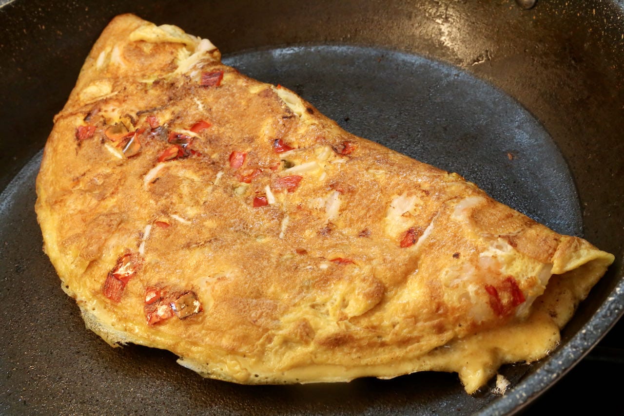 Flip the omelette into a halfmoon shape before serving. 
