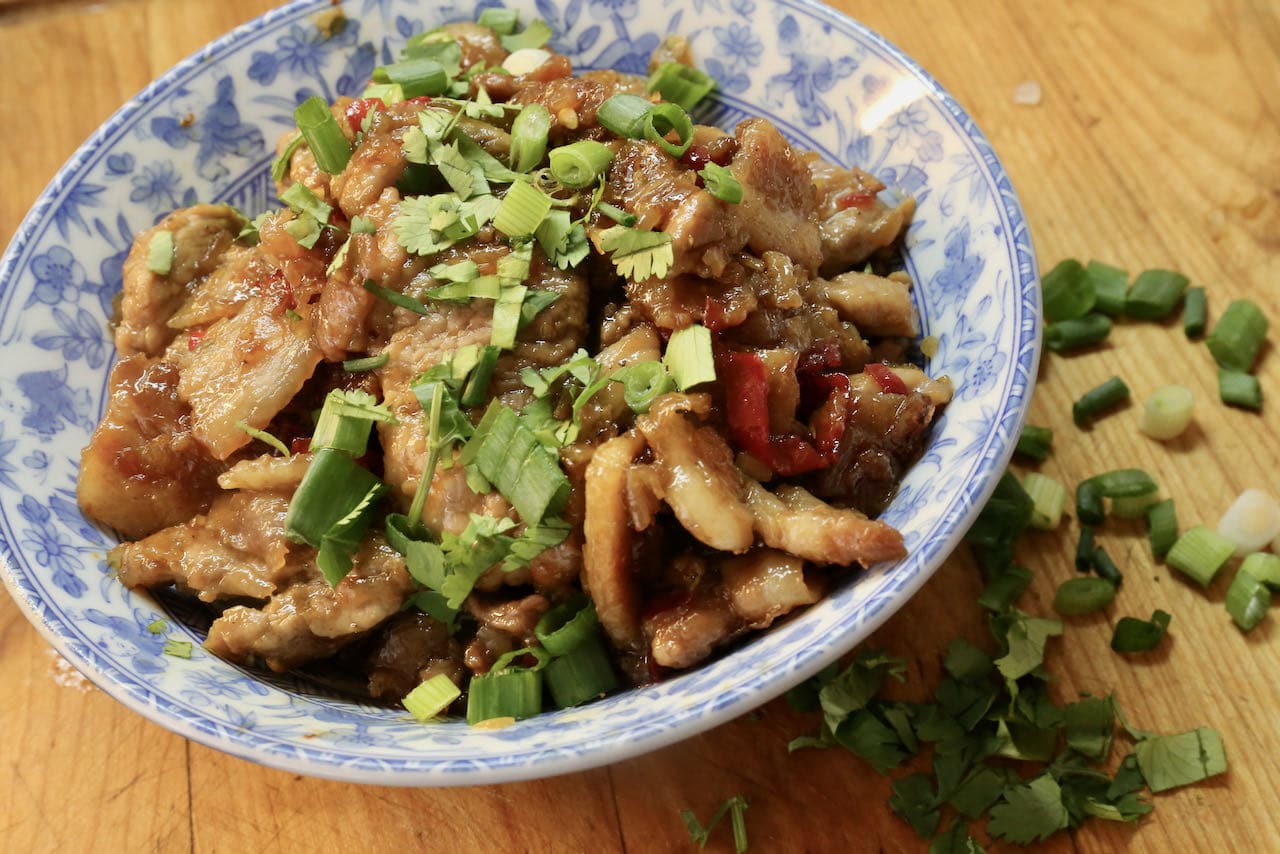 Serve Vietnamese Caramel Pork garnished with chopped cilantro and scallions.