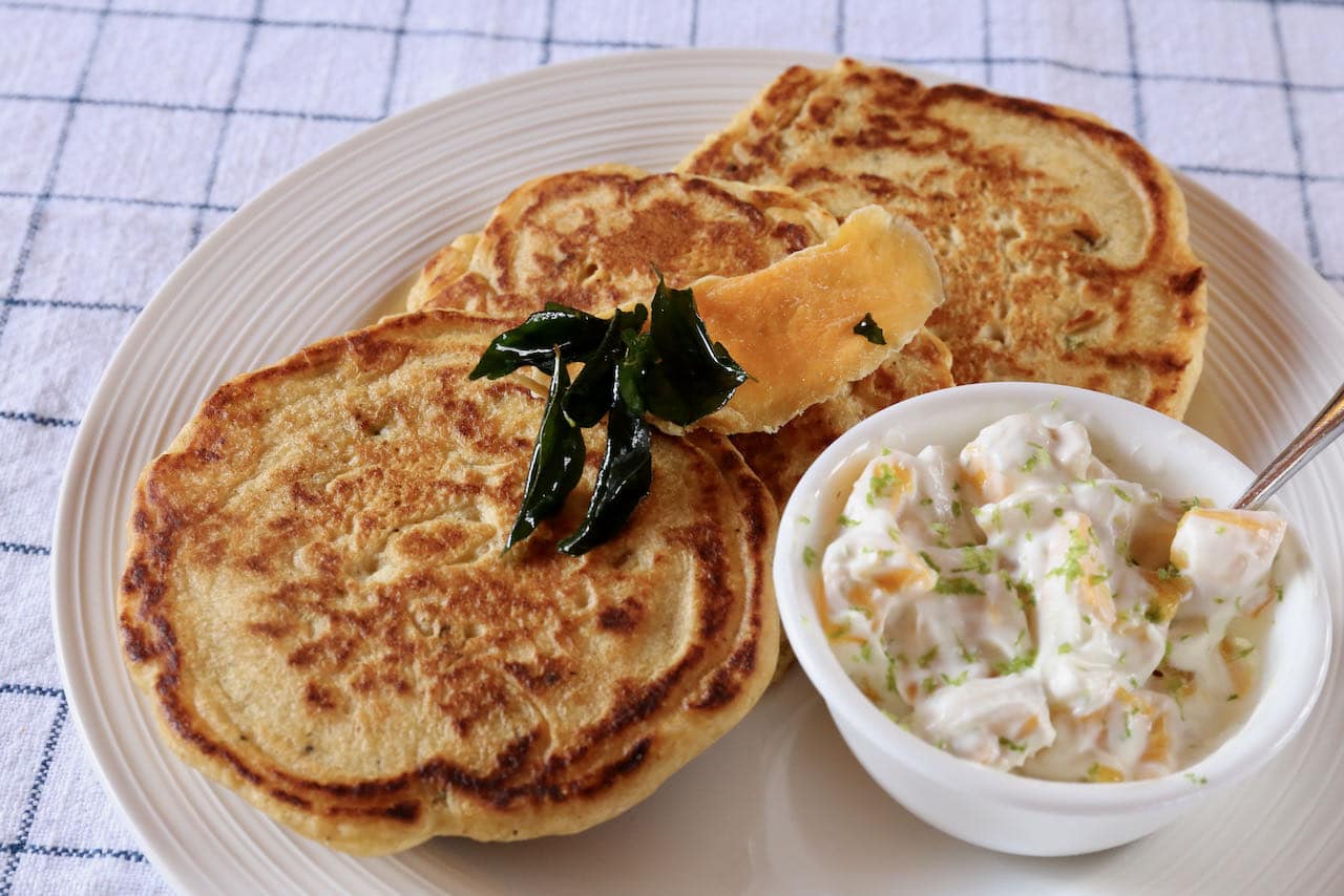 Serve Chickpea Flour Pancakes with crispy curry leaf, dried mango and yogurt lime mixture.
