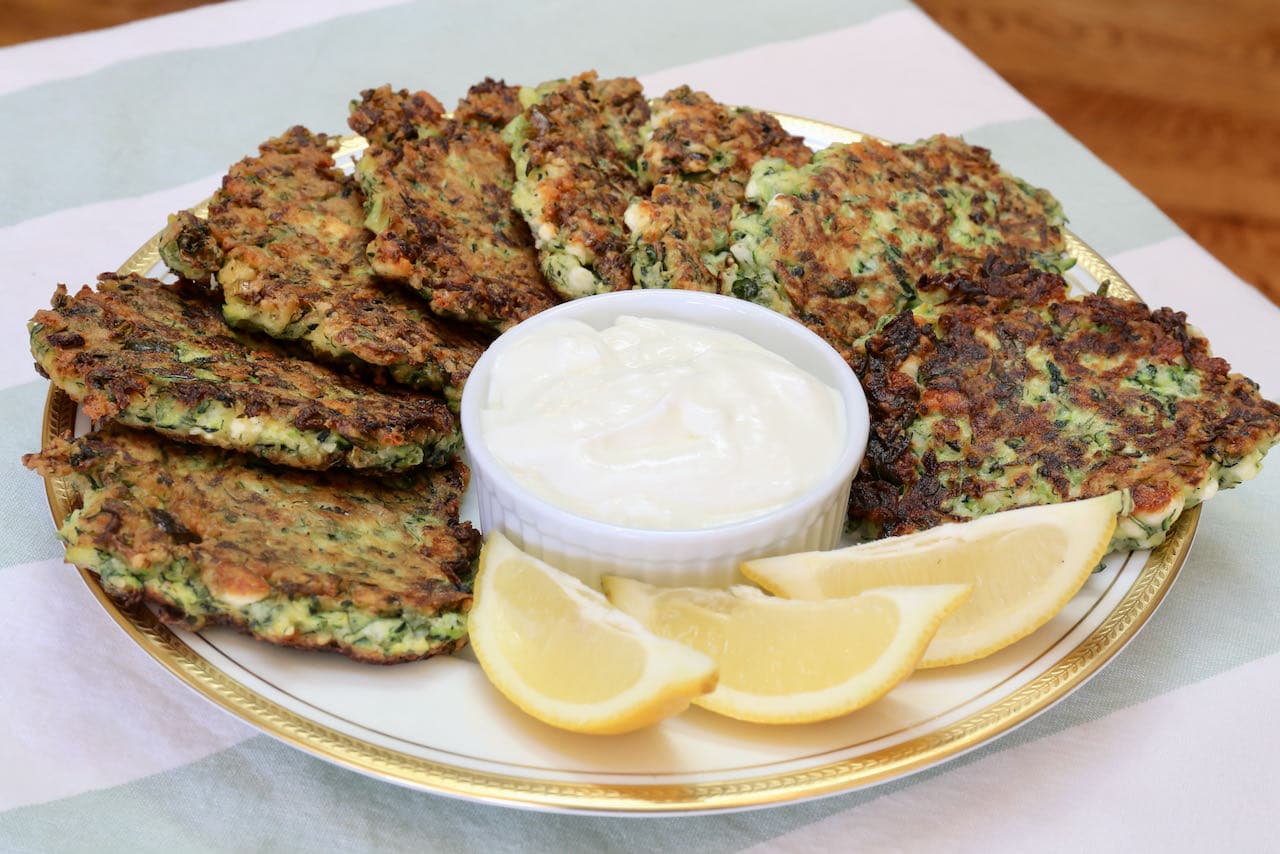 Serve Turkish Mucver Tarif with lemon wedges and sour cream or yogurt for dipping.