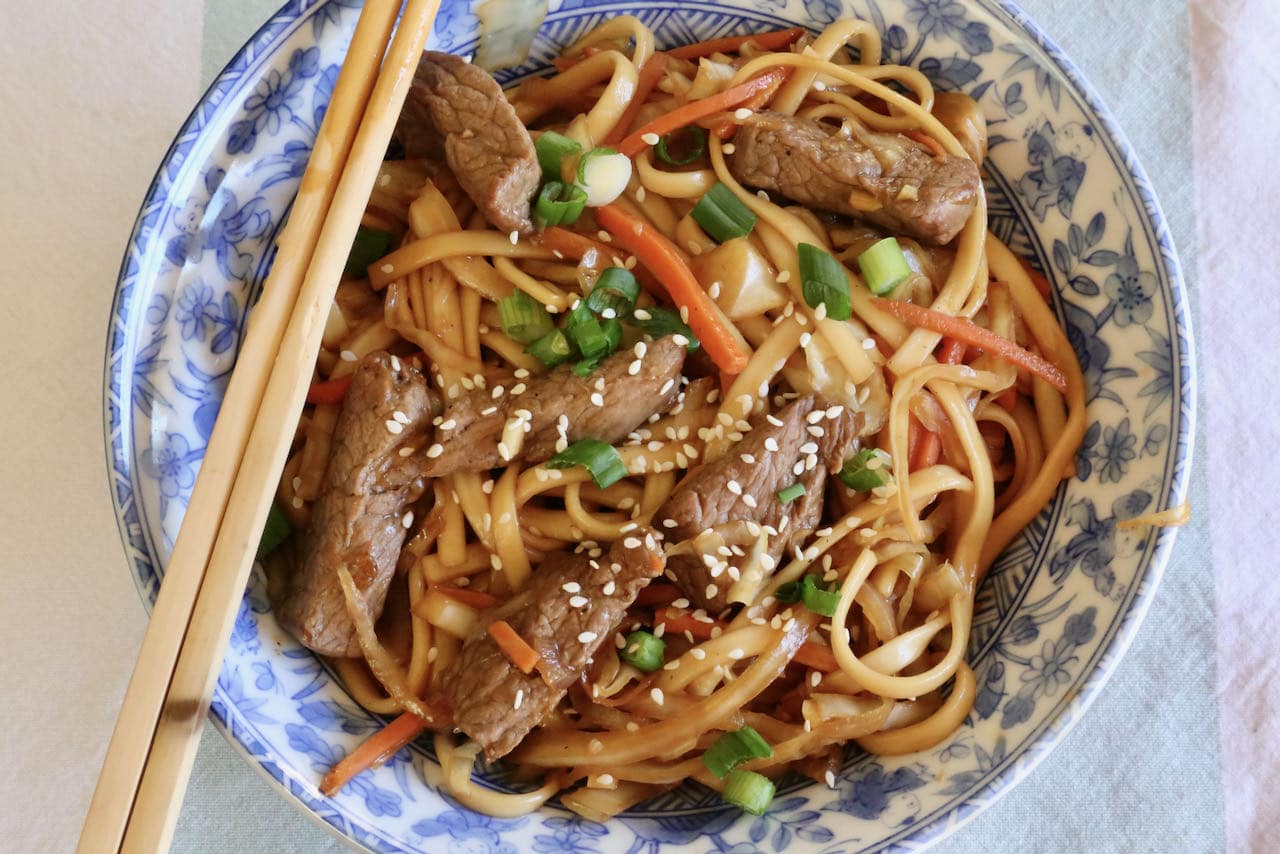 Serve Beef Yaki Udon sprinkled with chopped scallions and sesame seeds.