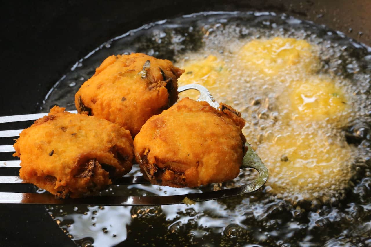Deep fry Parippu Vada until browned and crispy.