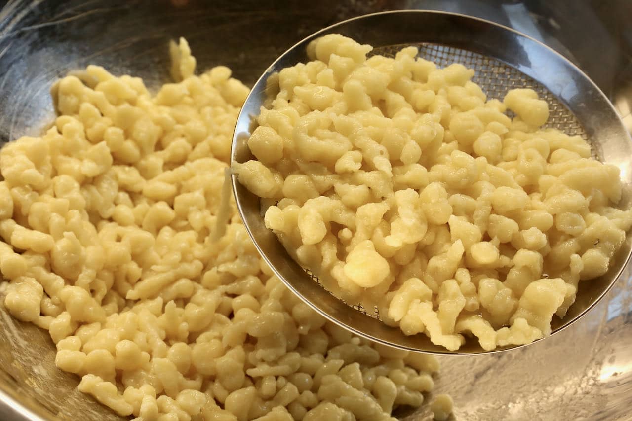 Toss cooked spaetzle in melted butter to ensure they don't stick together.