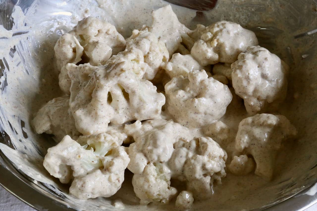 Toss Tandoori Gobi ingredients in a mixing bowl until cauliflower is evenly coated in yogurt sauce.