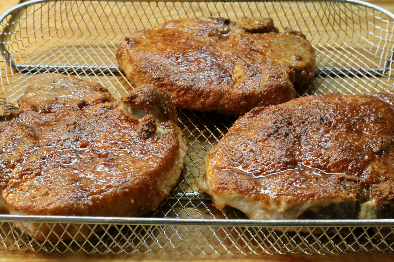 Cook Air Fryer Bone In Pork Chops until the exterior is crispy and interior is juicy.