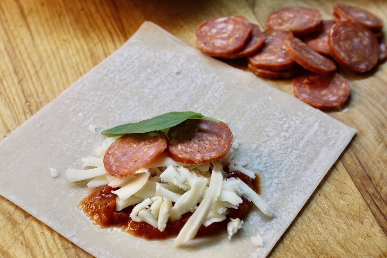 Wrap an egg roll wrapper into a packet filled with your favourite pizza toppings.
