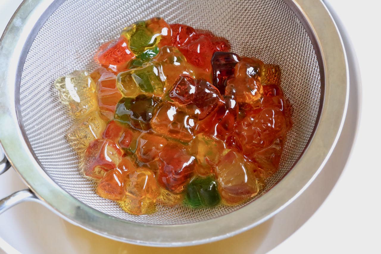 Strain Alcohol Gummy Bears with a sieve and use the leftover liquid as a fruity simple syrup to sweeten cocktails.