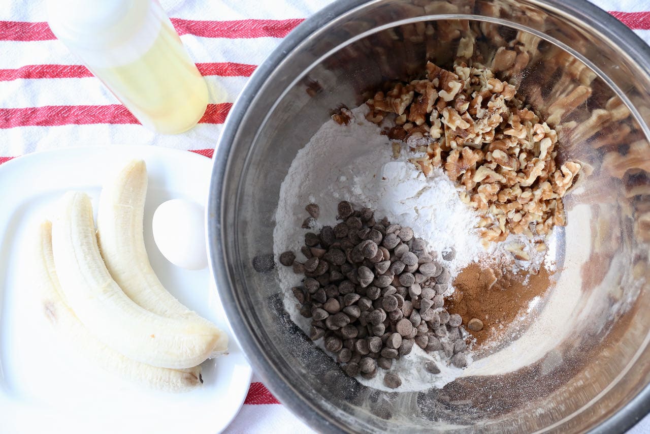 Prepare Banana Walnut Chocolate Chip Muffins in a large mixing bowl.