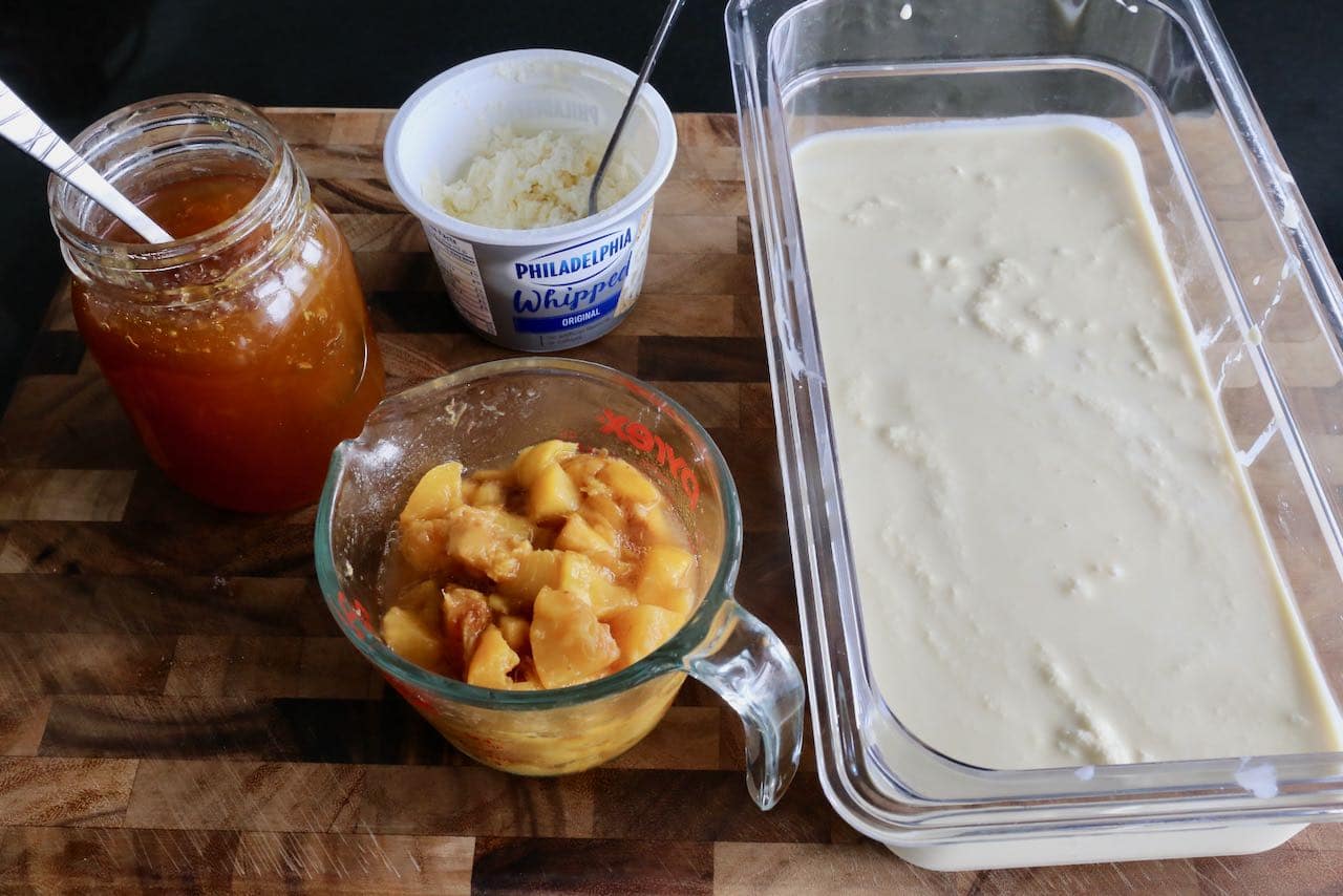Stir peach jam, chopped peaches and cream cheese into churned vanilla ice cream.