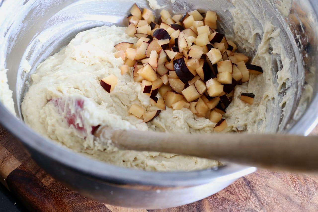 Gently stir fresh diced plums into spiced yogurt batter.