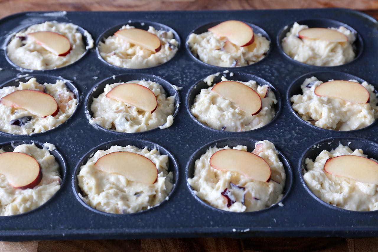 Spoon batter into muffin tins and top with a thin plum slice.