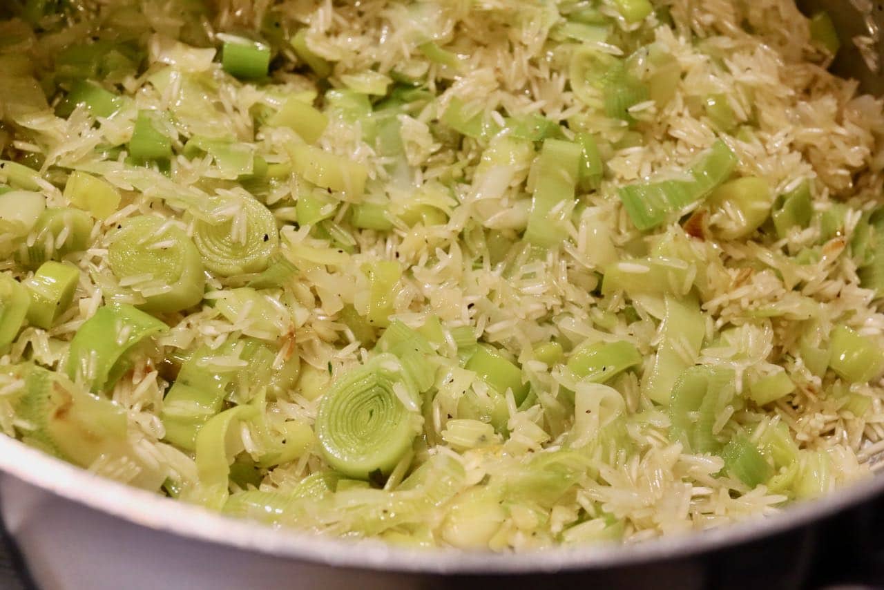 Cook leeks and rice in a large skillet over the stove.