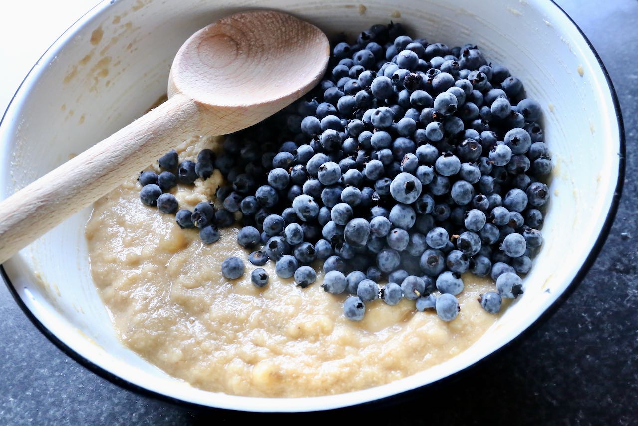 Stir fresh blueberries into gluten free banana muffin batter.