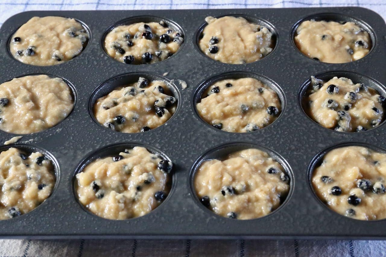 Scoop Gluten Free Blueberry Banana Muffins into greased tins.