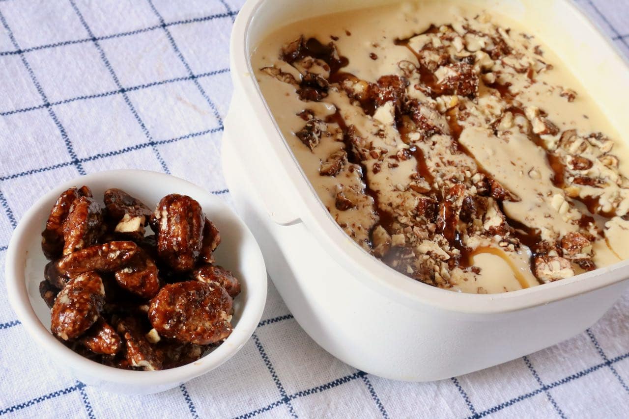 Pralines are candied pecans. Chop them into the ice cream for a delicious crunchy & nutty dessert. 