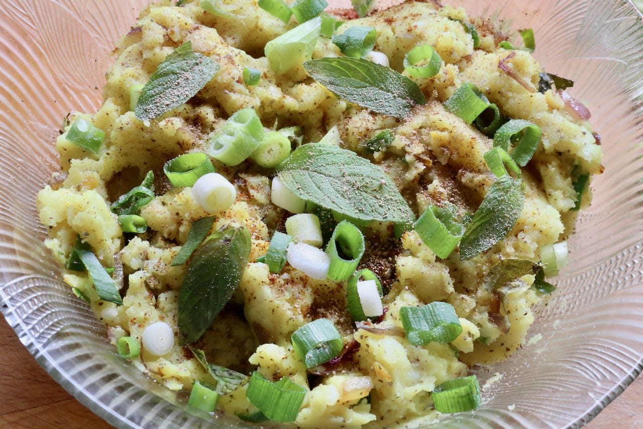 Garnish Aloo Bharta with fresh mint and sliced green onions.