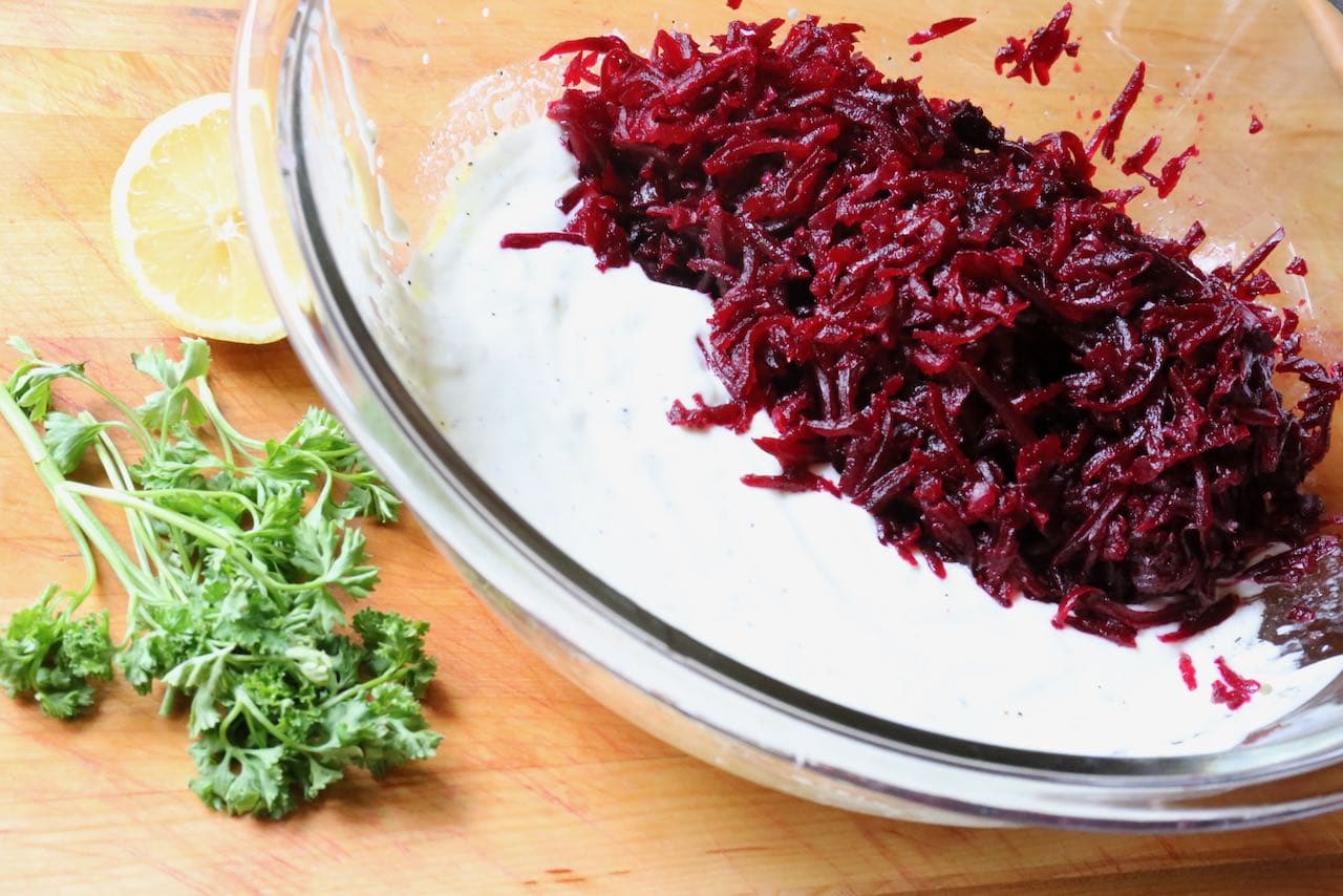In a large mixing bowl combine shredded beets, yogurt, parsley and lemon.
