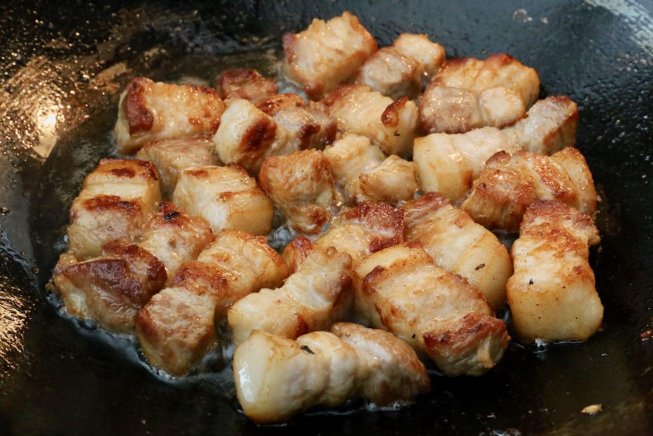 Cook pork belly in a hot walk until browned and crispy.