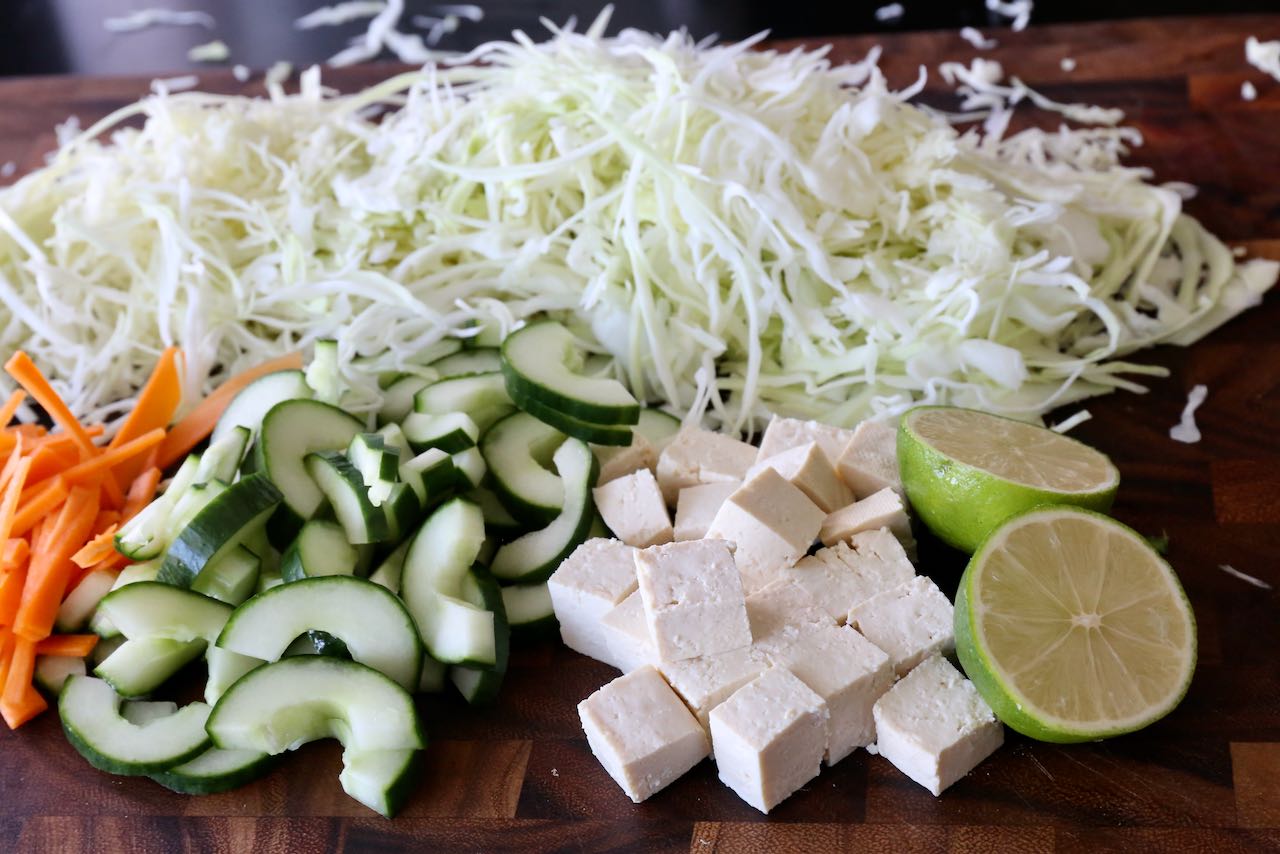Indonesian Coleslaw is prepared with cabbage, carrots, cucumber, lime and firm tofu.