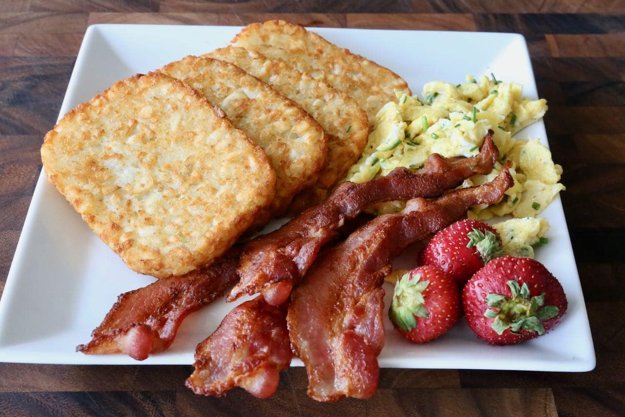 We love serving Air Fryer Hash Browns with eggs, bacon and fresh fruit at breakfast. 