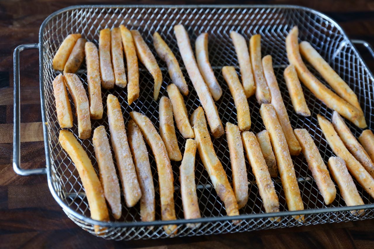 Scatter frozen McCain chips in a single layer on an air fryer basket before cooking.