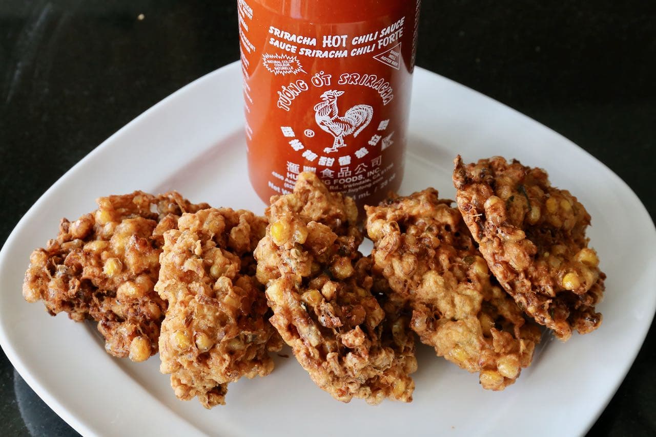 Serve Indonesian Corn Fritters with spicy Sriracha hot sauce.