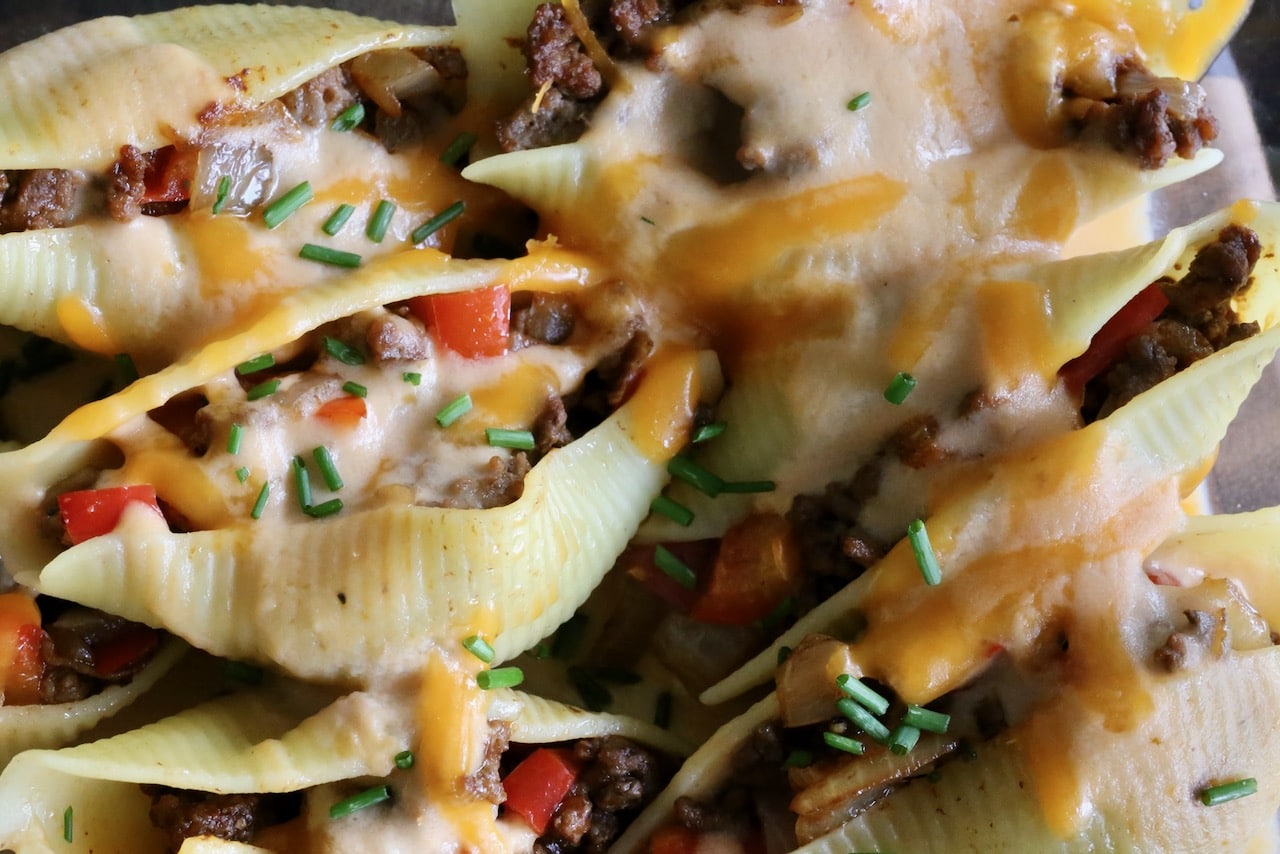 Drizzle Philly Cheesesteak Stuffed Shells with creamy cheese sauce before serving.