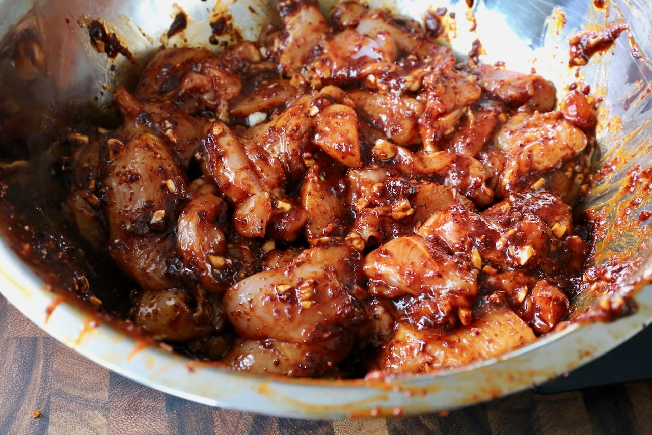 Toss sliced chicken thighs in the gochujang marinade. 