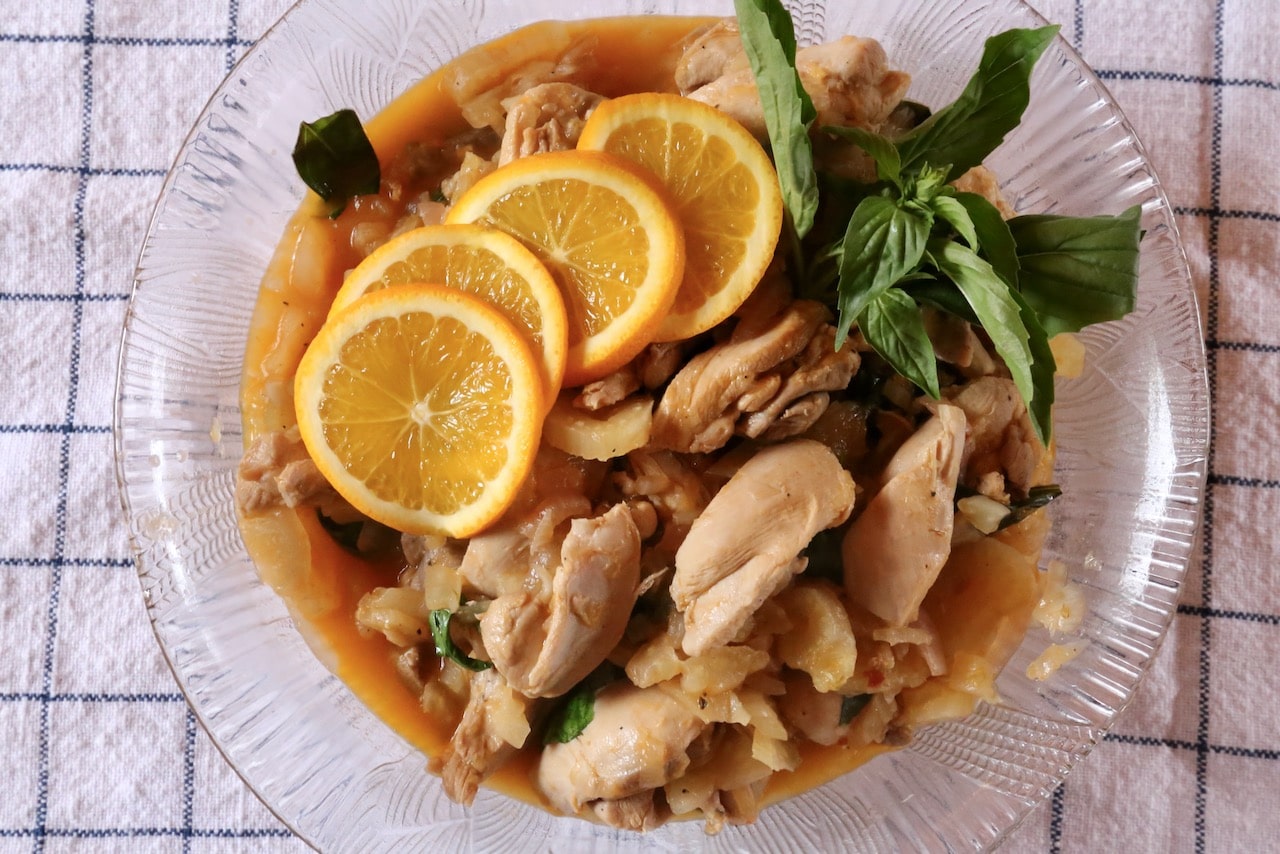 Garnish Provencal Chicken with slices of fresh orange and a sprig of basil.