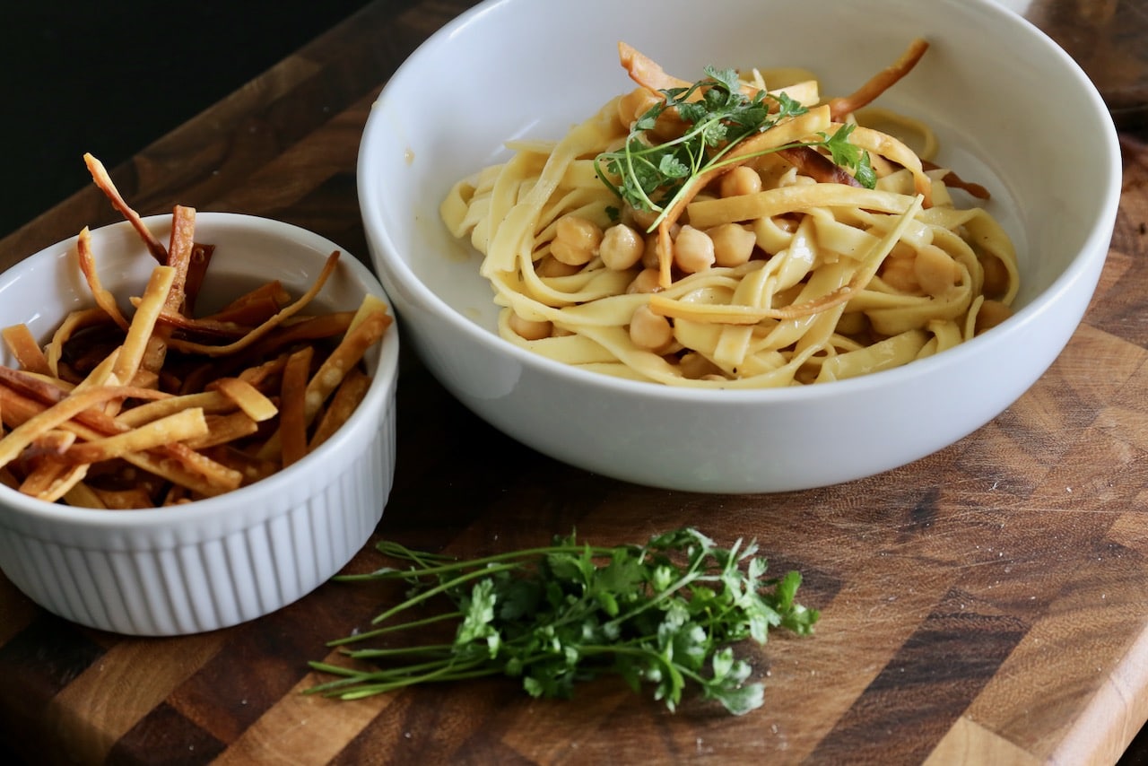 Serve Ciceri e Tria garnished with deep fried crispy pasta and parsley. 