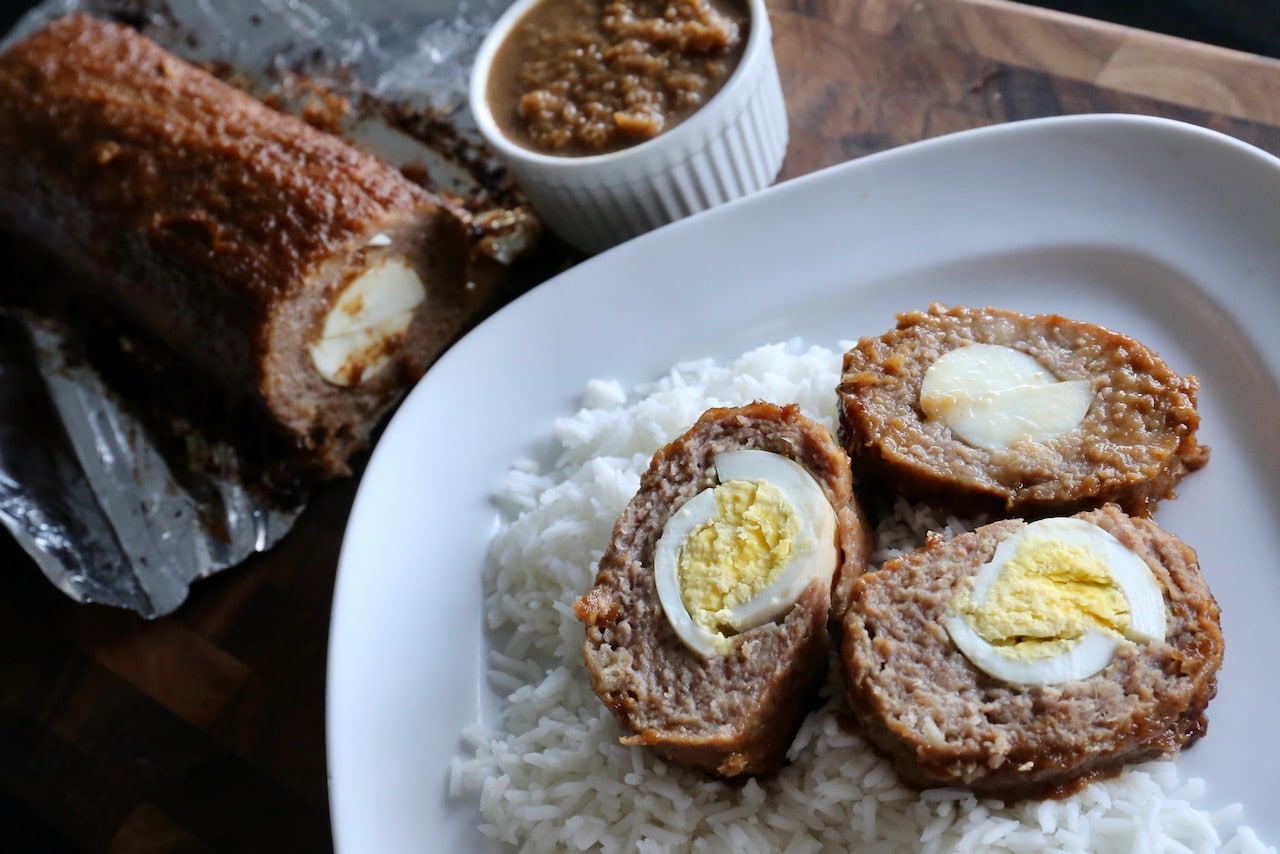 Serve slices of Embutido with steamed rice.