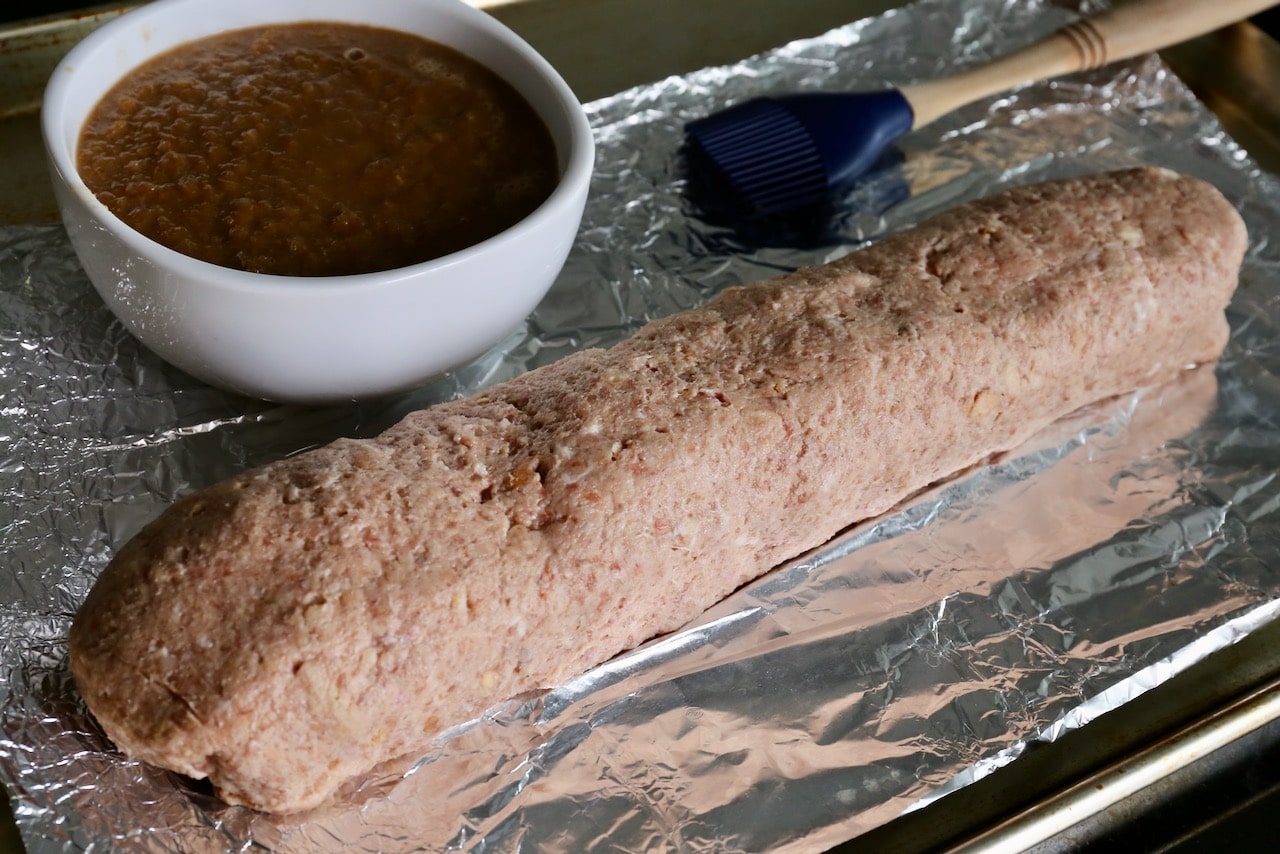 Use a pastry brush to slather the Embutido meatloaf with the pineapple glaze.