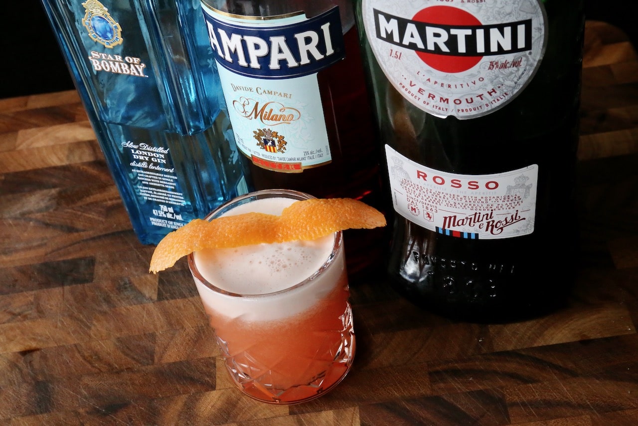 A classic Negroni Sour cocktail is made of gin, campari, sweet red vermouth and egg white.