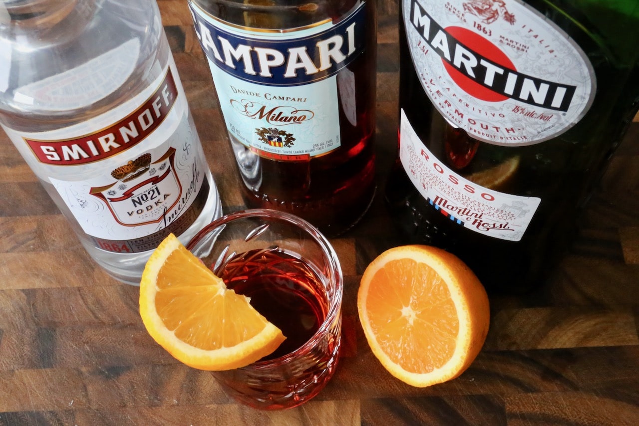 Garnish a Vodka Negroni Cocktail with an orange slice.