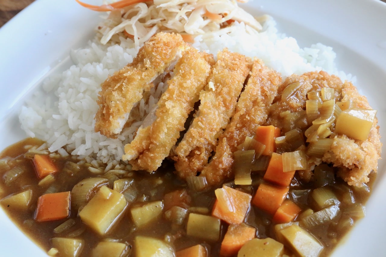 Japanese Katsu Curry is a dish featuring deep fried breaded chicken cutlet with vegetable gravy.