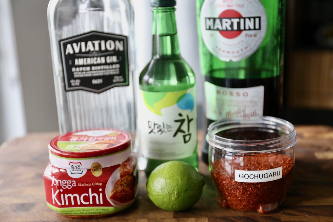 Korean Cocktail recipe ingredients include soju, gin, red vermouth, kimchi, lime and gochugaru.