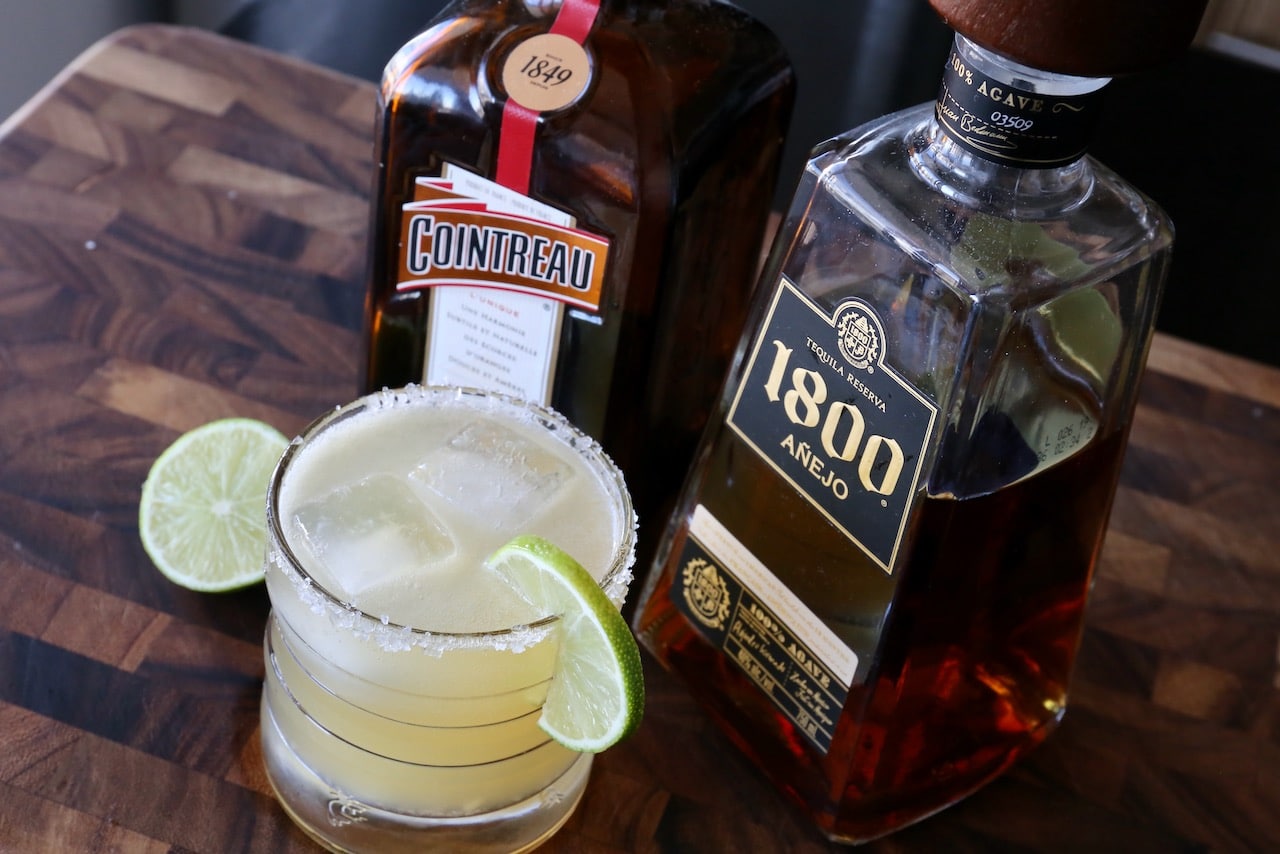 Serve an 1800 Margarita with a salted rim and lime wheel garnish.
