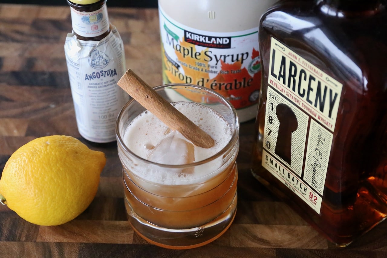 Garnish this festive Maple Whiskey Sour cocktail with a cinnamon stick.