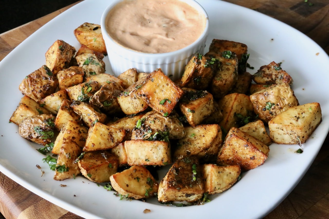 Serve Mexican style potatoes with spicy chipotle sour cream dip.