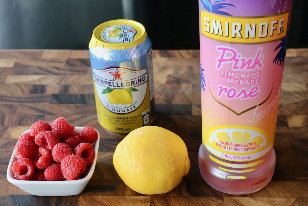 This easy vodka cocktail recipe features Smirnoff Pink Lemonade, San Pellegrino Limonata, lemon and fresh raspberries.